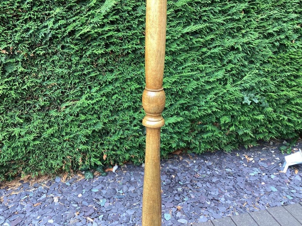 An Edwardian turned oak standard lamp featuring a tapered central column and a stepped circular base. View II