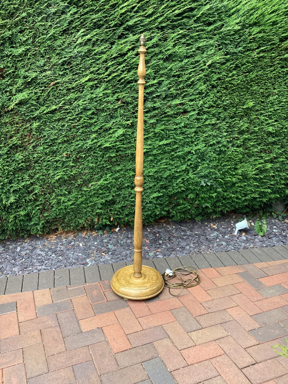 An Edwardian turned oak standard lamp featuring a tapered central column and a stepped circular base. View IV