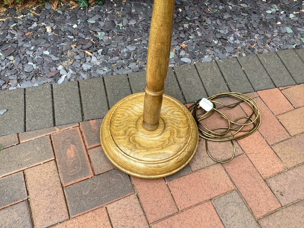 An Edwardian turned oak standard lamp featuring a tapered central column and a stepped circular base. View VI