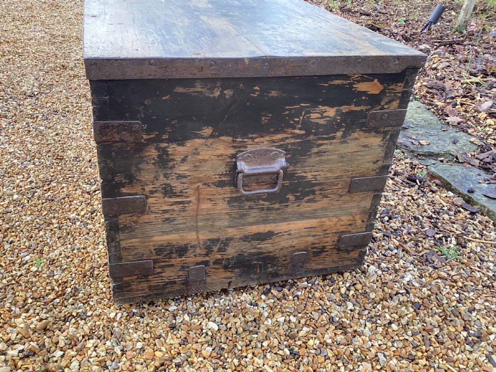A rectangular antique dark wood military campaign chest featuring stencilled white lettering and iron strap reinforcements. View IX