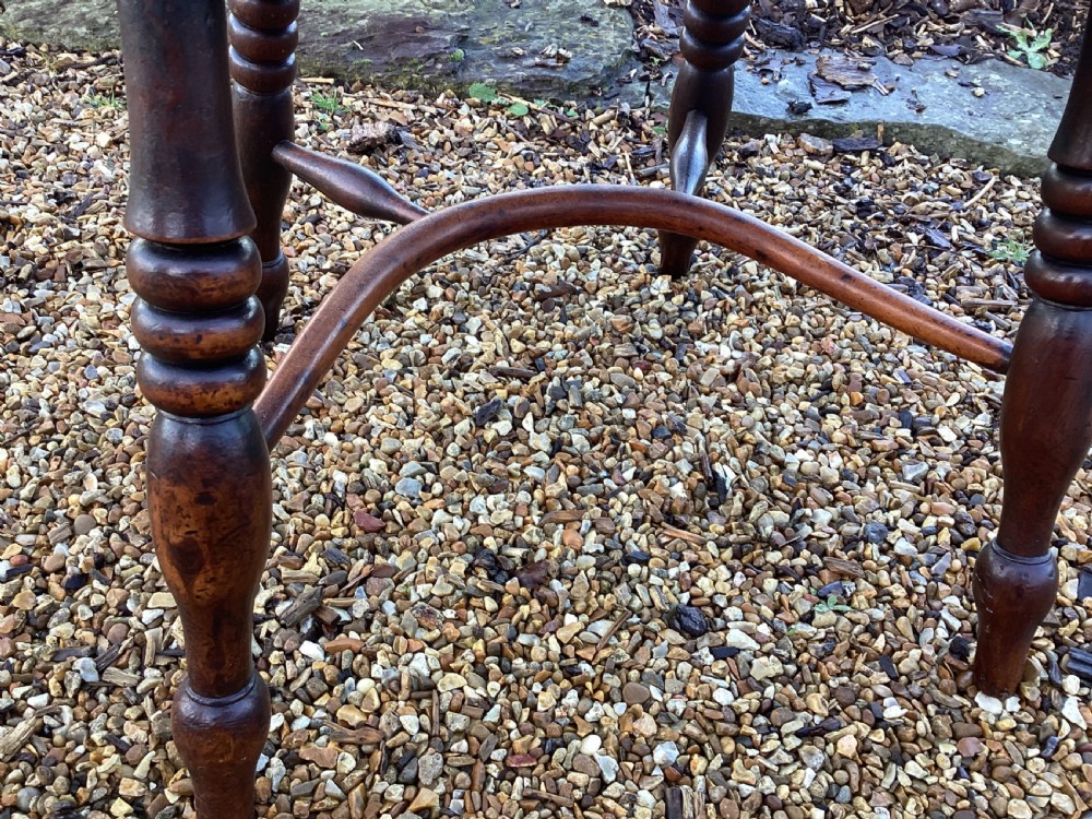 A wooden Georgian Windsor armchair featuring a hoop back, central pierced splat, vertical spindles, shaped seat, turned legs, and curved armrests. View VIII
