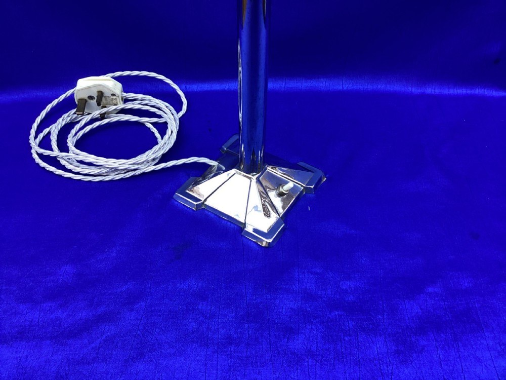 An Art Deco chrome table lamp featuring a central column stem, stepped square base, and a mottled frosted glass bell shade decorated with black geometric diamond motifs. View X