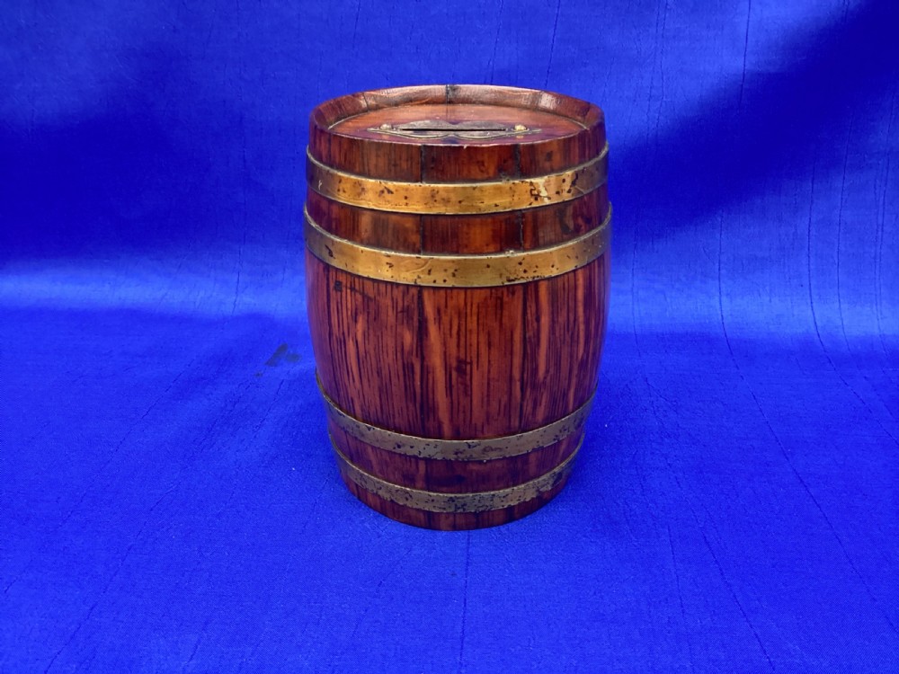 An Edwardian oak coopered barrel money box