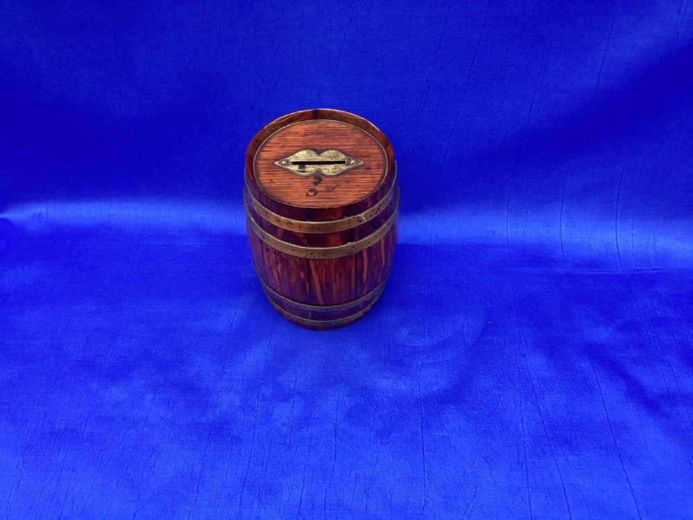 An Edwardian oak coopered barrel money box View V
