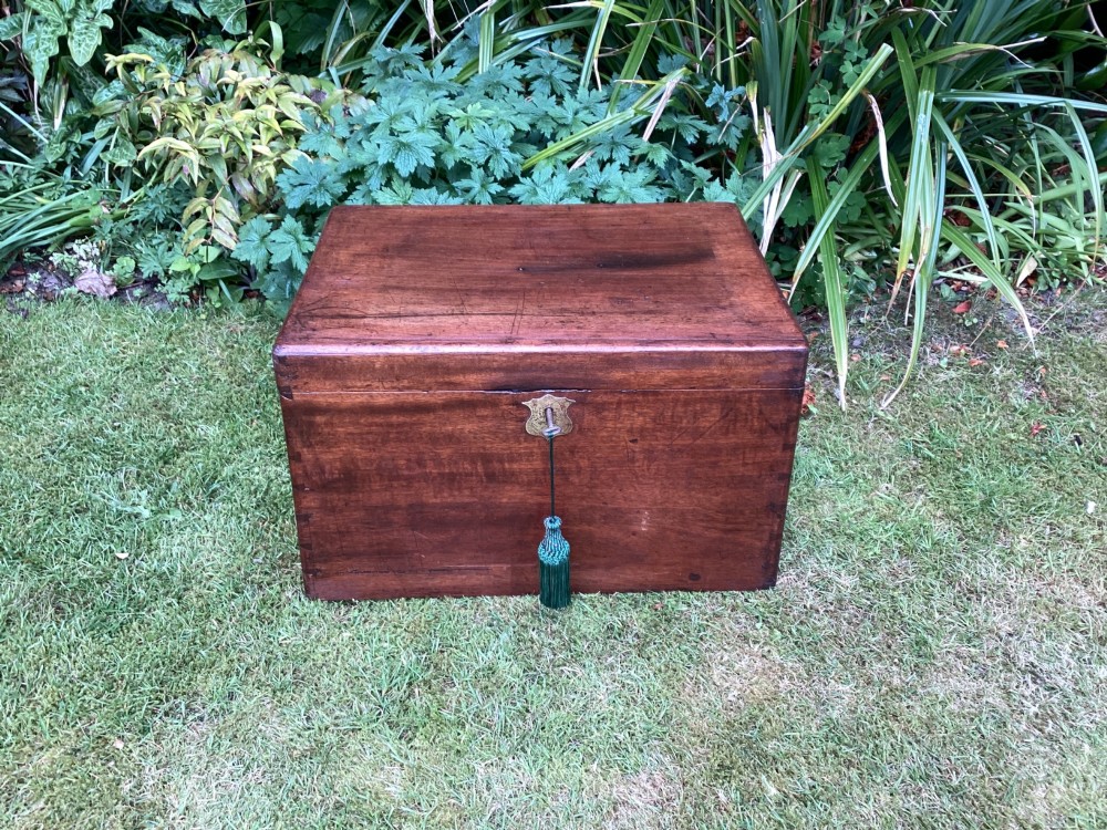 A rectangular Victorian mahogany deed box featuring a hinged lid, polished wood grain, and a central brass escutcheon with an inserted key.