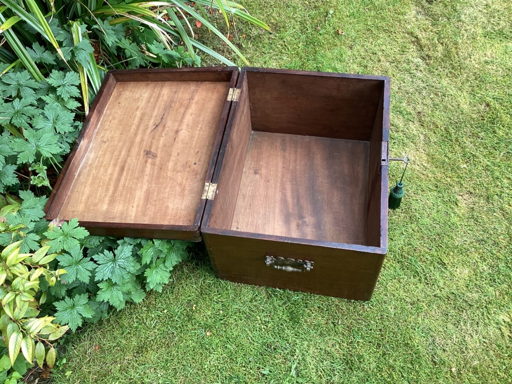 A rectangular Victorian mahogany deed box featuring a hinged lid, polished wood grain, and a central brass escutcheon with an inserted key. View VI