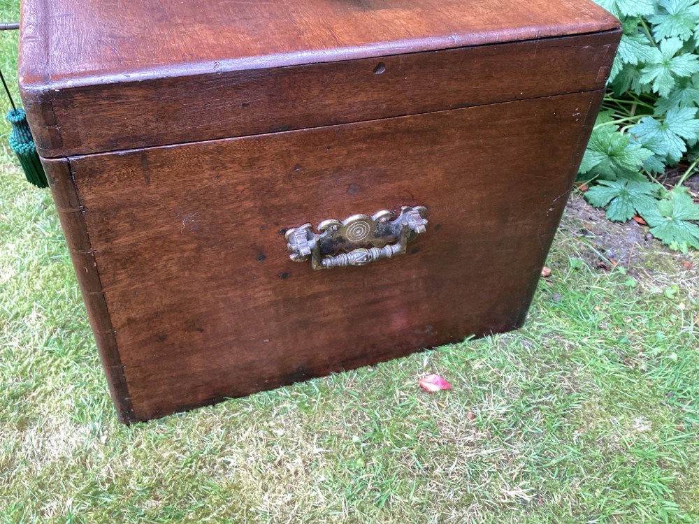 A rectangular Victorian mahogany deed box featuring a hinged lid, polished wood grain, and a central brass escutcheon with an inserted key. View IX