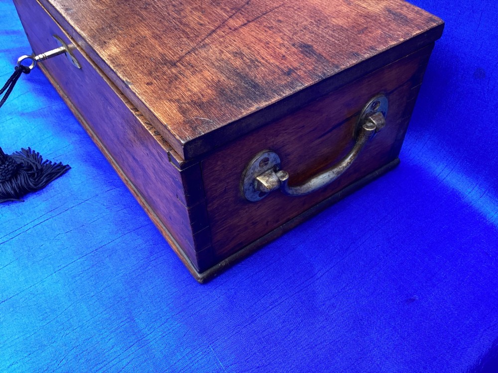 A rectangular Georgian mahogany tool box featuring a hinged lid with a central brass inlay plaque, a keyhole with a brass escutcheon, and visible dovetail joinery. View II