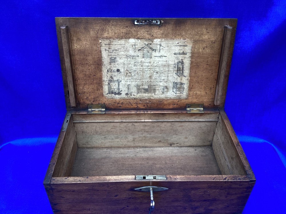 A rectangular Georgian mahogany tool box featuring a hinged lid with a central brass inlay plaque, a keyhole with a brass escutcheon, and visible dovetail joinery. View IV