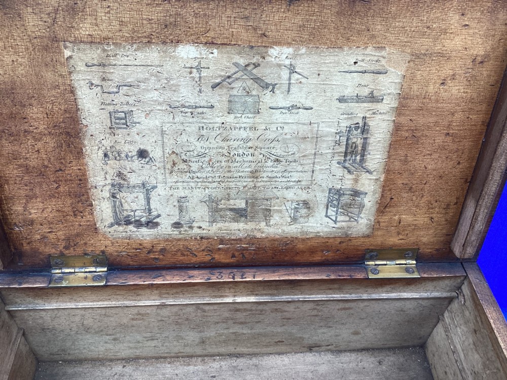 A rectangular Georgian mahogany tool box featuring a hinged lid with a central brass inlay plaque, a keyhole with a brass escutcheon, and visible dovetail joinery. View V