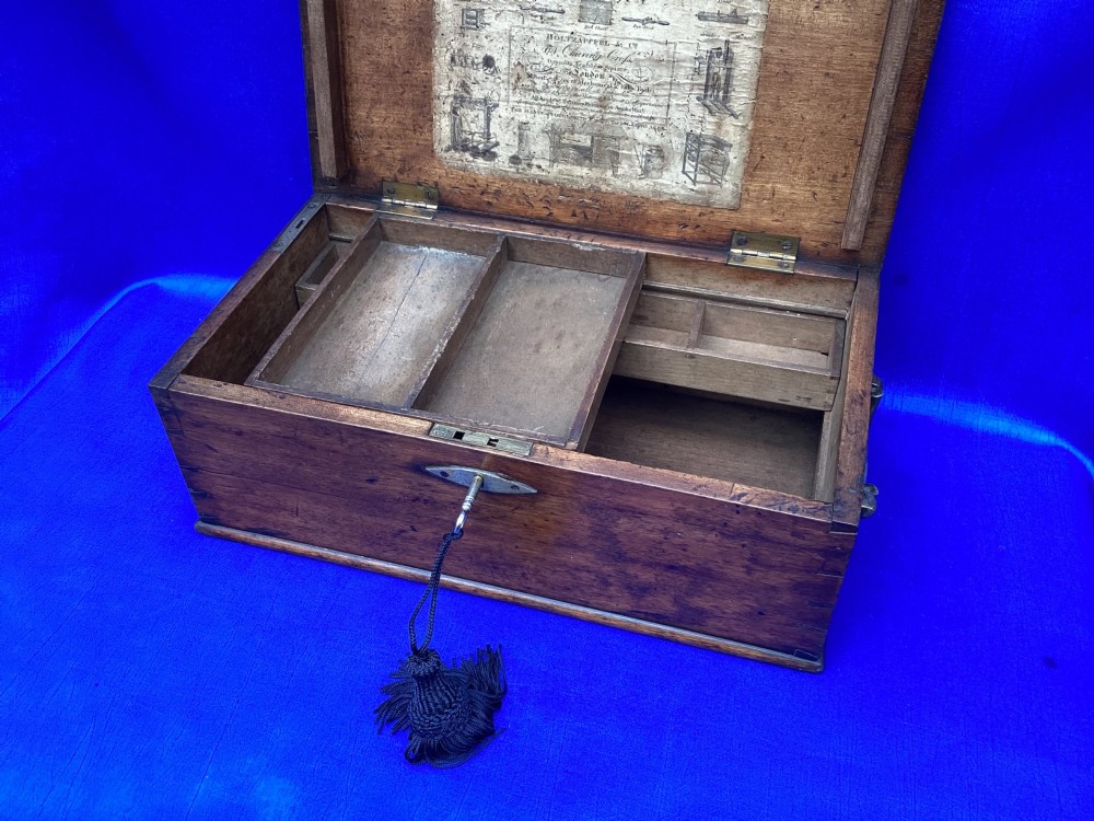A rectangular Georgian mahogany tool box featuring a hinged lid with a central brass inlay plaque, a keyhole with a brass escutcheon, and visible dovetail joinery. View VII