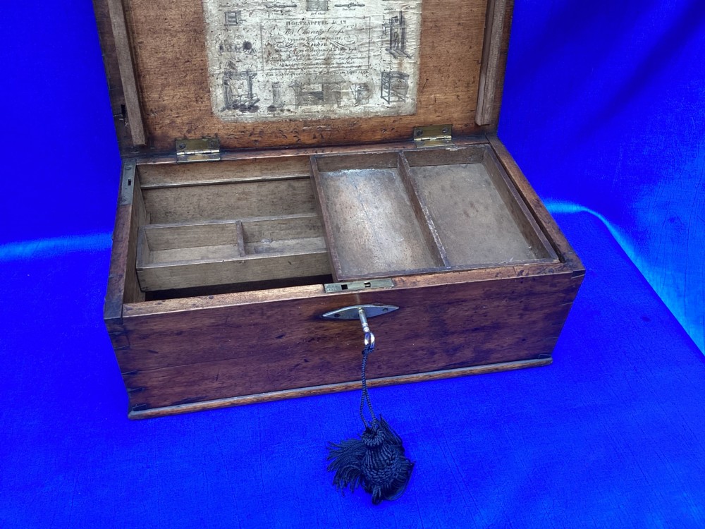 A rectangular Georgian mahogany tool box featuring a hinged lid with a central brass inlay plaque, a keyhole with a brass escutcheon, and visible dovetail joinery. View VIII