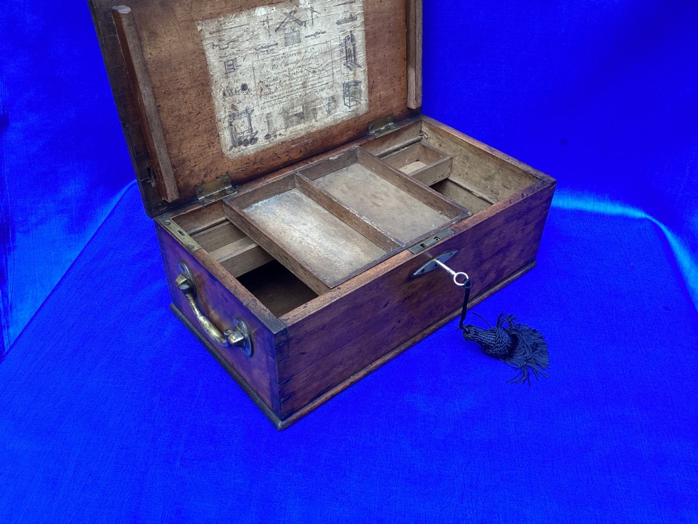 A rectangular Georgian mahogany tool box featuring a hinged lid with a central brass inlay plaque, a keyhole with a brass escutcheon, and visible dovetail joinery. View XI