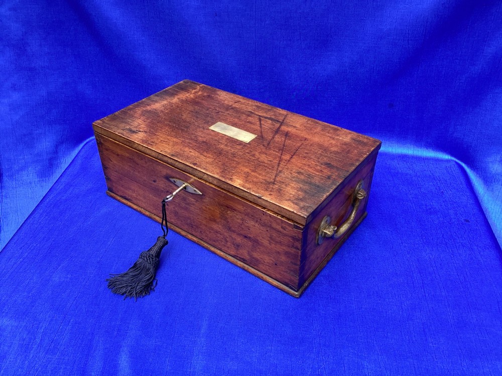 A rectangular Georgian mahogany tool box featuring a hinged lid with a central brass inlay plaque, a keyhole with a brass escutcheon, and visible dovetail joinery. View XII