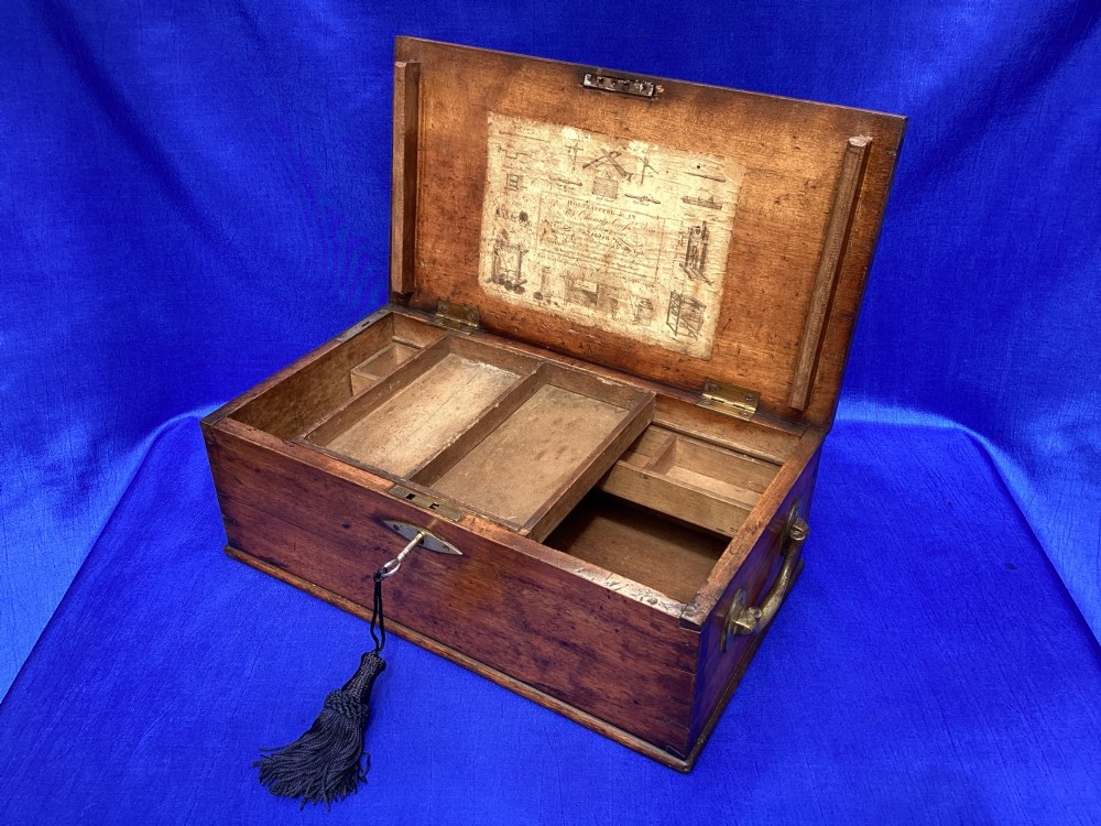 A rectangular Georgian mahogany tool box featuring a hinged lid with a central brass inlay plaque, a keyhole with a brass escutcheon, and visible dovetail joinery. View XIII