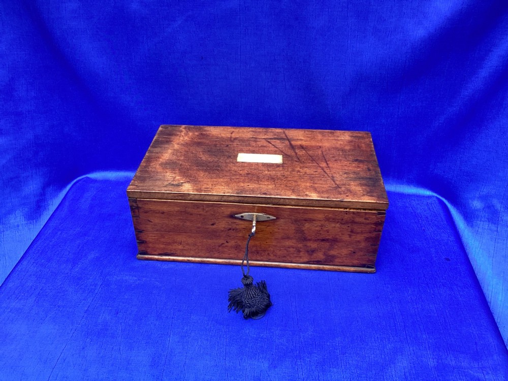 A rectangular Georgian mahogany tool box featuring a hinged lid with a central brass inlay plaque, a keyhole with a brass escutcheon, and visible dovetail joinery. View XIV