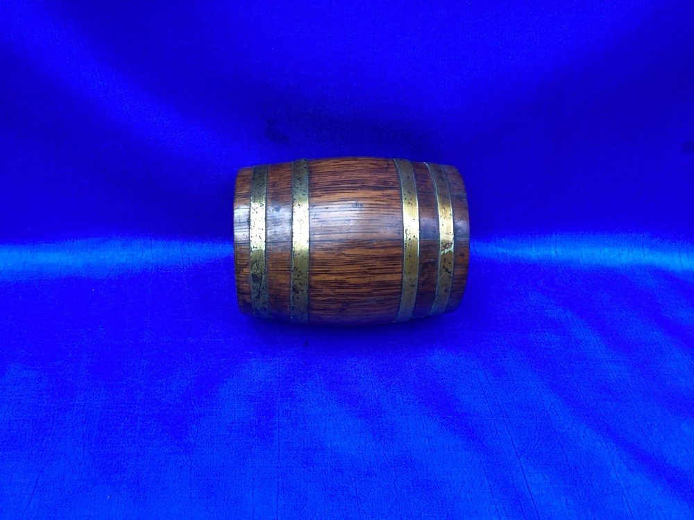 An Edwardian oak money box crafted in the form of a miniature coopered barrel with brass hoops. View V