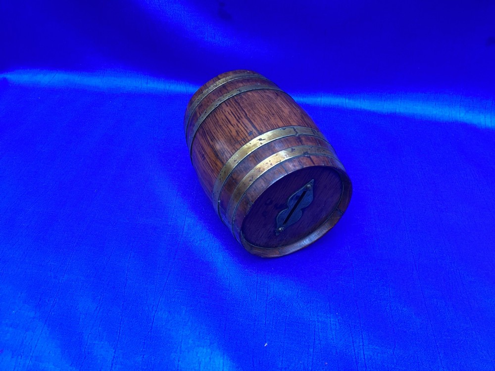 An Edwardian oak money box crafted in the form of a miniature coopered barrel with brass hoops. View VI