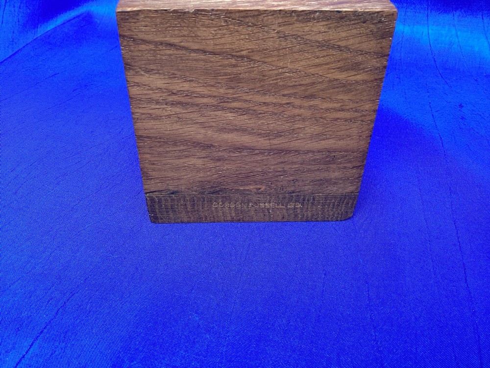 A pair of triangular solid oak wooden bookends featuring visible wood grain and a natural warm brown finish. View VIII