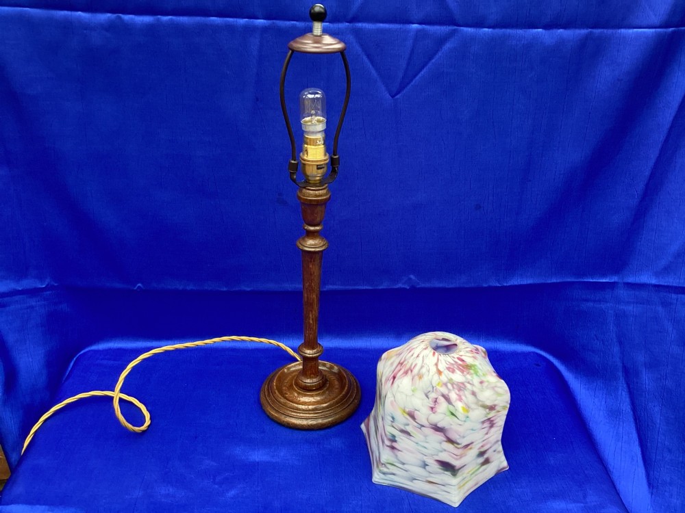 An antique turned oak table lamp featuring a bell-shaped variegated spatter glass shade and a yellow fabric-covered cable. View III