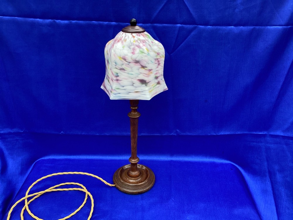 An antique turned oak table lamp featuring a bell-shaped variegated spatter glass shade and a yellow fabric-covered cable. View IV