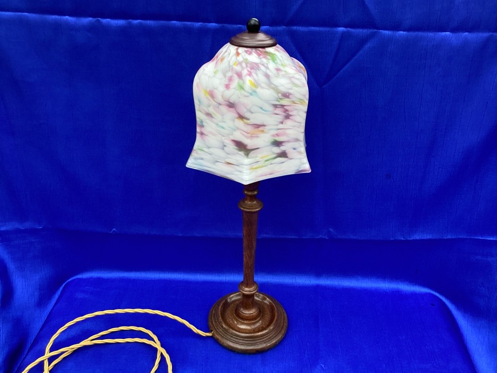 An antique turned oak table lamp featuring a bell-shaped variegated spatter glass shade and a yellow fabric-covered cable. View V