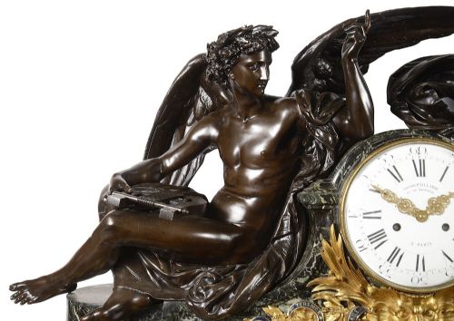 fig 1. A nineteenth-century French bronze and gilt-bronze mantel clock featuring two allegorical figures seated beside a dial on a green marble base.