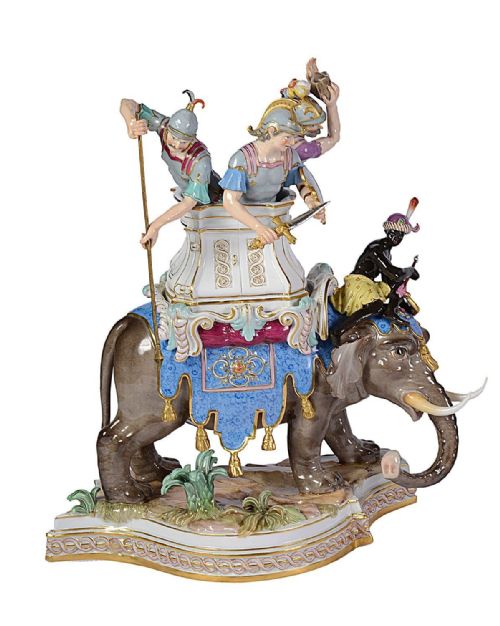 fig 1. A pair of elaborate 19th-century Meissen porcelain sculptures depicting war elephants with armed soldiers and attendants on gilded bases.