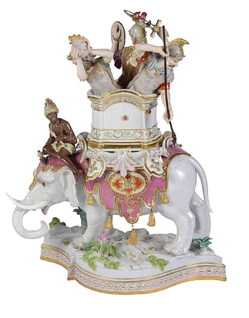 fig 2. A pair of elaborate 19th-century Meissen porcelain sculptures depicting war elephants with armed soldiers and attendants on gilded bases.