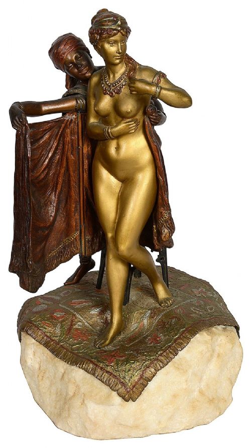 fig 1. Cold painted bronze sculpture depicting a semi-nude woman and an attendant standing upon a carpet-patterned surface mounted on an alabaster base.