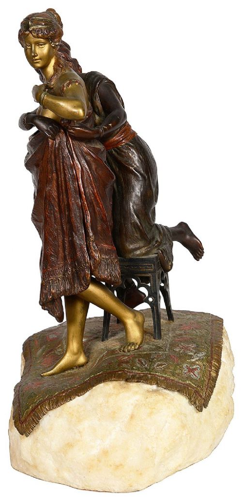 Cold painted bronze sculpture depicting a semi-nude woman and an attendant standing upon a carpet-patterned surface mounted on an alabaster base. View IV