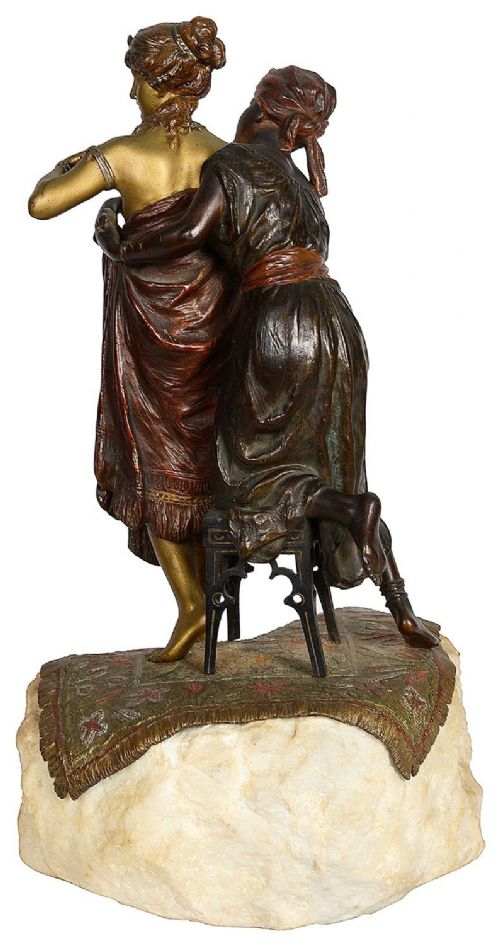 Cold painted bronze sculpture depicting a semi-nude woman and an attendant standing upon a carpet-patterned surface mounted on an alabaster base. View V