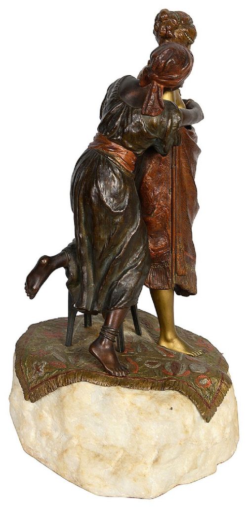 Cold painted bronze sculpture depicting a semi-nude woman and an attendant standing upon a carpet-patterned surface mounted on an alabaster base. View VI