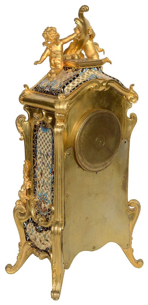 A 19th-century French Louis XVI style gilt bronze mantel clock decorated with multi-coloured enamel scrollwork and topped with twin cherub figures. View IX