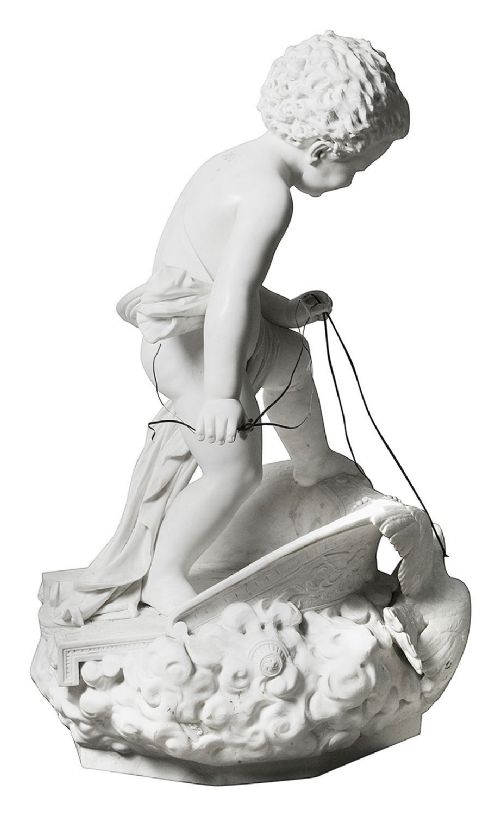 A 19th-century white carved marble sculpture depicting a child figure standing on a shell-shaped chariot pulled by a bird over clouds. View VI