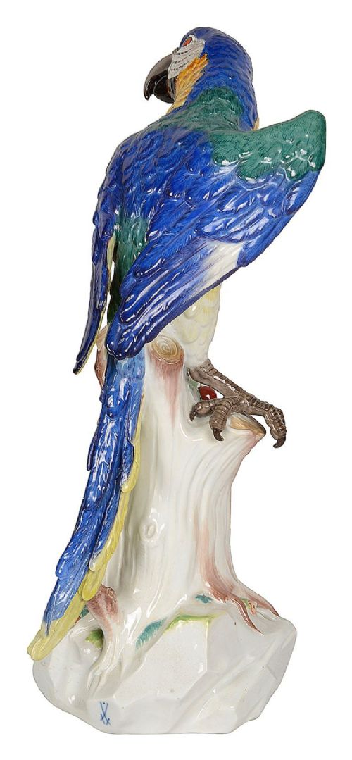 A late 19th-century Meissen porcelain parrot figurine with yellow, blue, and green plumage perched on a tree stump base with red cherries. View V