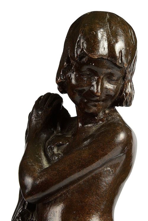 fig 1. A dark brown patinated bronze sculpture depicting two young children near a rock formation, with one standing above holding a towel and the other crouching at the base.