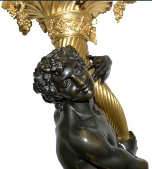 A pair of French Louis XVI style bronze candelabra featuring dark patinated classical figures holding scrolling multi-light gilt bronze candle branches, elevated on red marble bases. View VI