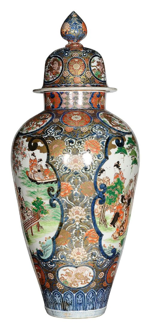 A pair of large 19th-century Japanese Imari porcelain lidded vases featuring painted reserves depicting figures in garden settings, surrounded by cobalt blue, orange, green, and gold patterns. View VI