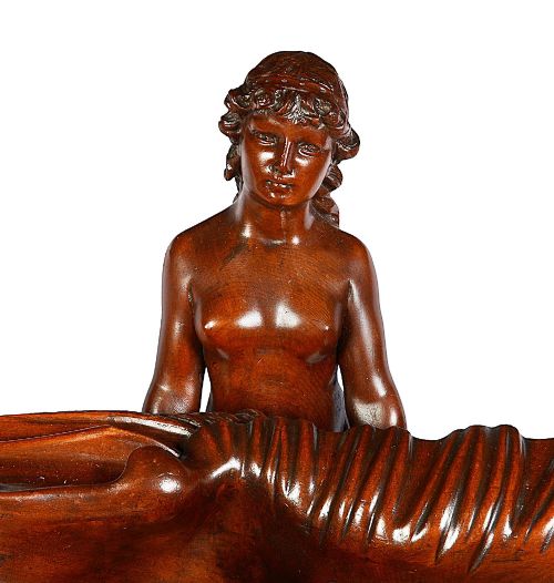 fig 1. An 18th-century style carved walnut jardiniere featuring three mythical figures supporting a large shell basin on a tripod base.