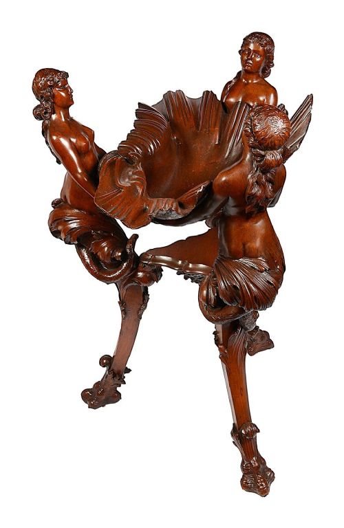 An 18th-century style carved walnut jardiniere featuring three mythical figures supporting a large shell basin on a tripod base. View VII