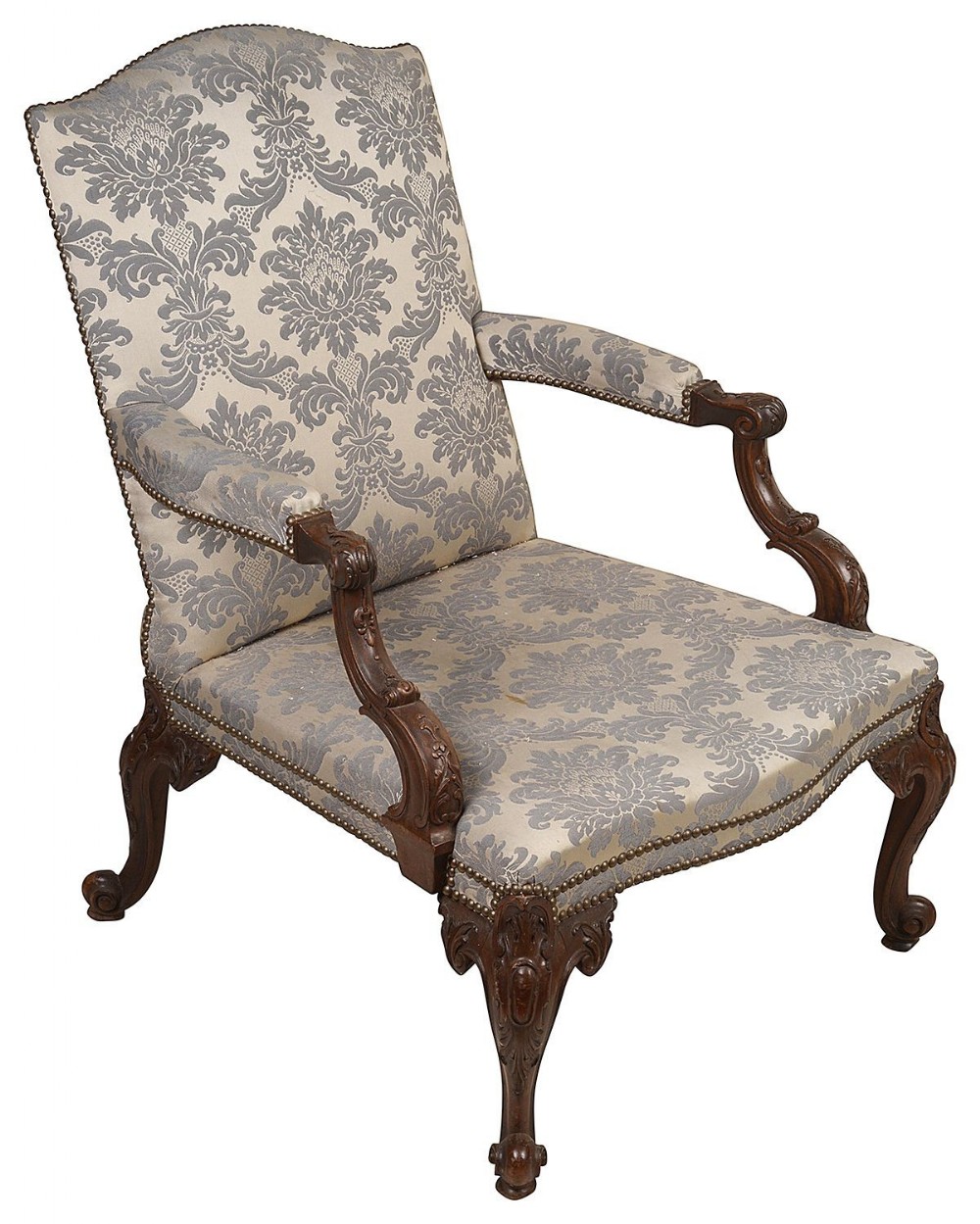 A George II style mahogany Gainsborough armchair upholstered in patterned grey damask fabric with carved cabriole legs and brass stud trim.