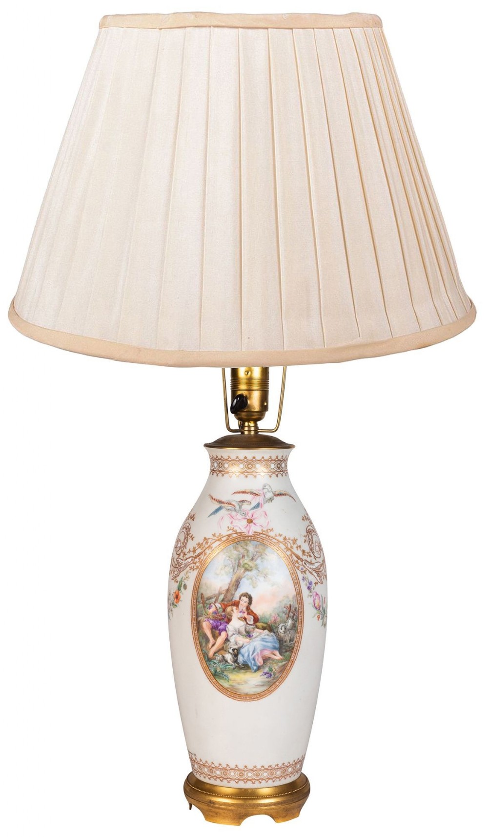 A nineteenth-century French Paris porcelain table lamp featuring a hand-painted pastoral scene framed in gilding with a pleated cream shade.