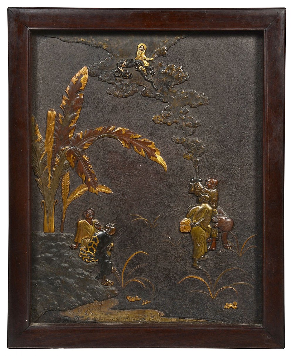 A dark patinated rectangular bronze panel framed in wood, featuring raised figures, foliage, and smoke leading to a seated deity in gold inlay.
