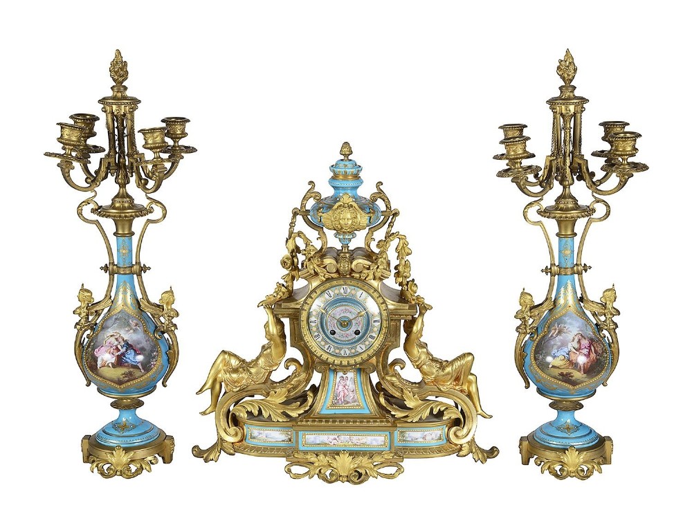 A nineteenth-century three-piece French clock garniture set featuring a central gilt bronze and sky blue porcelain mantel clock flanked by two matching five-light candelabra.