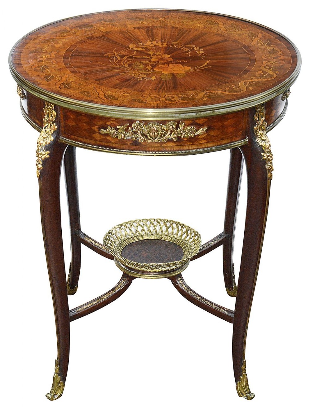 A circular late nineteenth-century French gueridon side table featuring floral marquetry inlay, gilt-brass mounts, curved legs, and a central brass basket undertier.