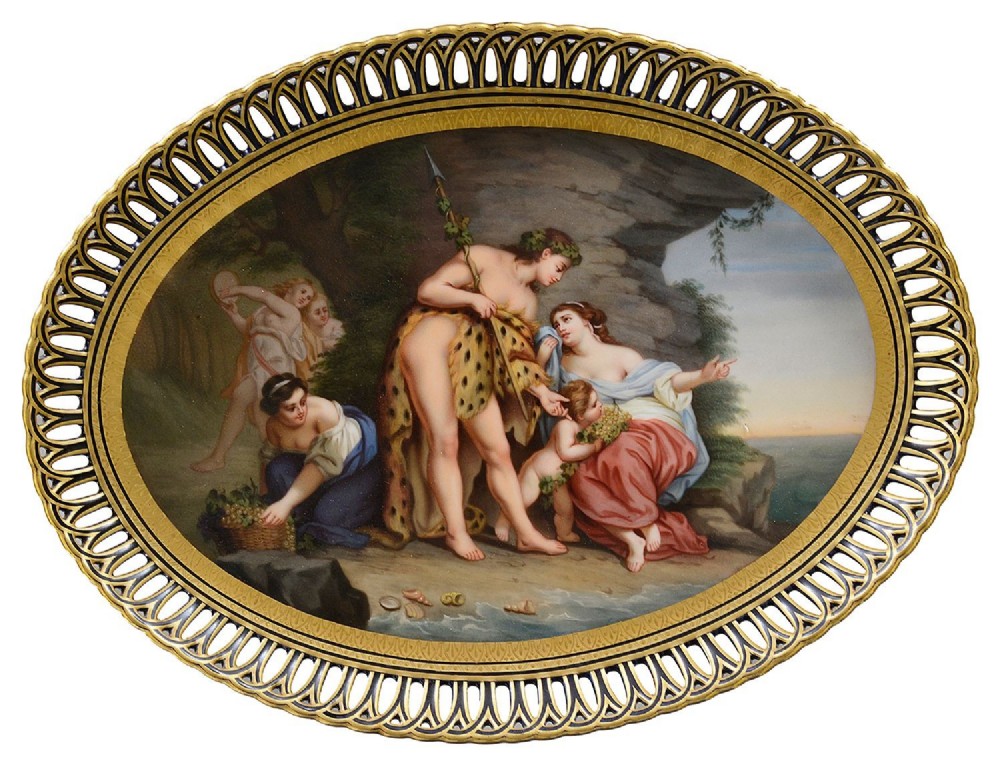An oval 19th-century Vienna porcelain charger with a pierced gilded rim surrounding a painted classical scene depicting Bacchus and Ariadne.