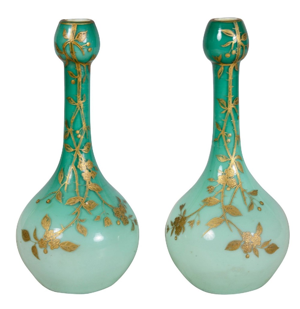 A pair of late 19th-century green Bohemian glass vases featuring long slender necks and gilded floral decorations.
