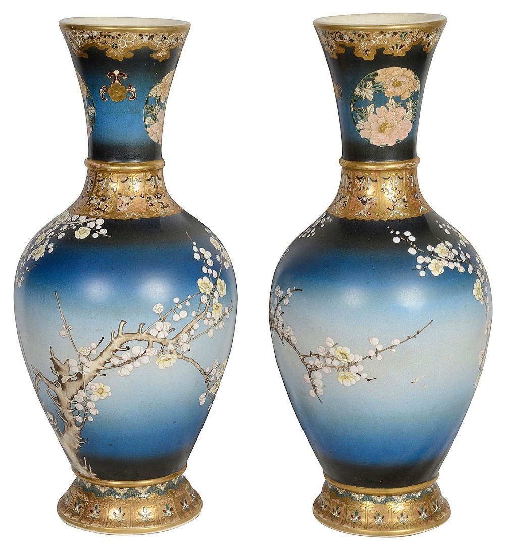 A pair of tall Japanese Satsuma baluster vases featuring gradient blue grounds decorated with hand-painted blossom trees and gilt geometric borders. View II