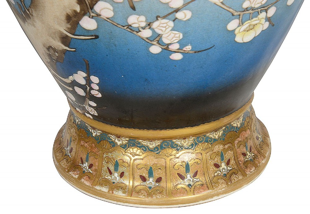 A pair of tall Japanese Satsuma baluster vases featuring gradient blue grounds decorated with hand-painted blossom trees and gilt geometric borders. View IX